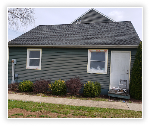 Residential home exterior with siding painting in progress
