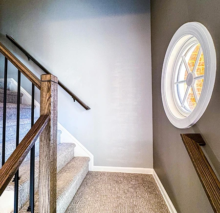 Staircase with round window and railing